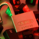 Open padlock surrounded by loose computer keyboard keys, symbolizing password security and digital access