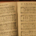 Open hymn book resting on an old piano displaying sheet music for Yield Not to Temptation and The Way of the Cross Leads Home