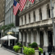 Wall Street financial district in New York City with American flags displayed among the buildings