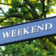 Directional sign displaying the word Weekend with an arrow pointing to the right