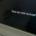 Windows laptop or tablet displaying the Windows logo and a message asking users to wait while a system update installs