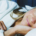 Woman wearing a white robe lying comfortably on a bed while resting