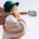 Woman-Walking-With-Guitar-on-Shoulder-and-Green-Hat.jpg
