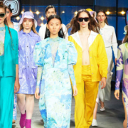 Group of women walking forward in a variety of fashionable dresses and outfits, each expressing a different personal style