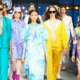 Group of women walking forward in a variety of fashionable dresses and outfits, each expressing a different personal style
