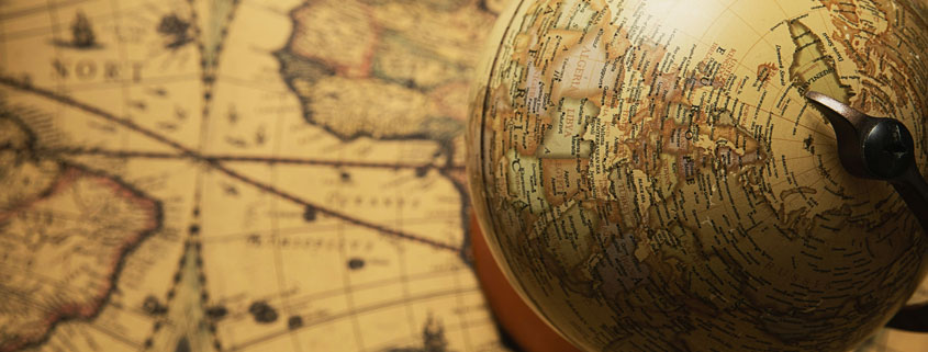 World-Globe-Resting-on-Geographic-Map-of-the-Earth Globe representing planet Earth positioned on top of a geographic world map, illustrating different perspectives of global geography