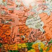 Geographic globe displaying Canada and the surrounding regions of North America on a detailed world map